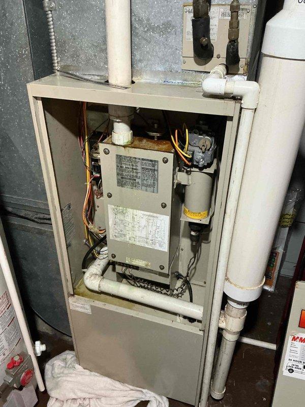 Responded to report of condensation on floor near furnace. Upon inspection, found humidifier had been previously disconnected, leaving open water supply line that was causing moisture accumulation. Secured and capped the water line connection to prevent further leakage. Inspected furnace operation and condensate drain system to ensure proper function. Verified no additional moisture issues present and cleaned affected area around furnace base.