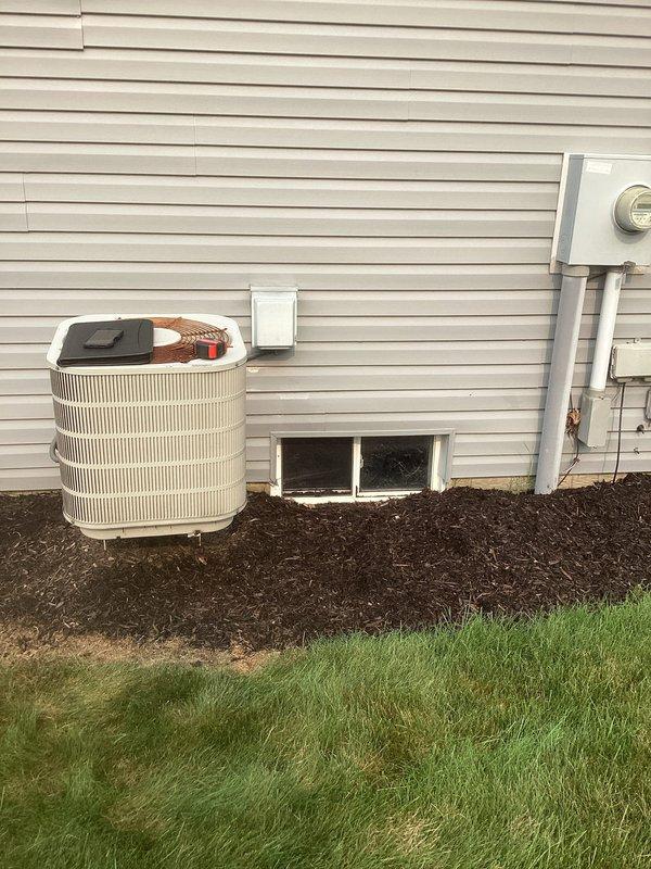 Conducted comprehensive site assessment for complete air conditioning system replacement at residential property. Evaluated existing outdoor condensing unit positioned on foundation mulch bed with refrigerant lines running to junction box, and inspected indoor air handler unit located in basement mechanical room alongside water heater. Documented current system configuration including copper line sets, electrical connections, and ductwork layout. Provided detailed estimate for replacement of both outdoor condensing unit and indoor air handler components with updated equipment to improve cooling efficiency and system performance.