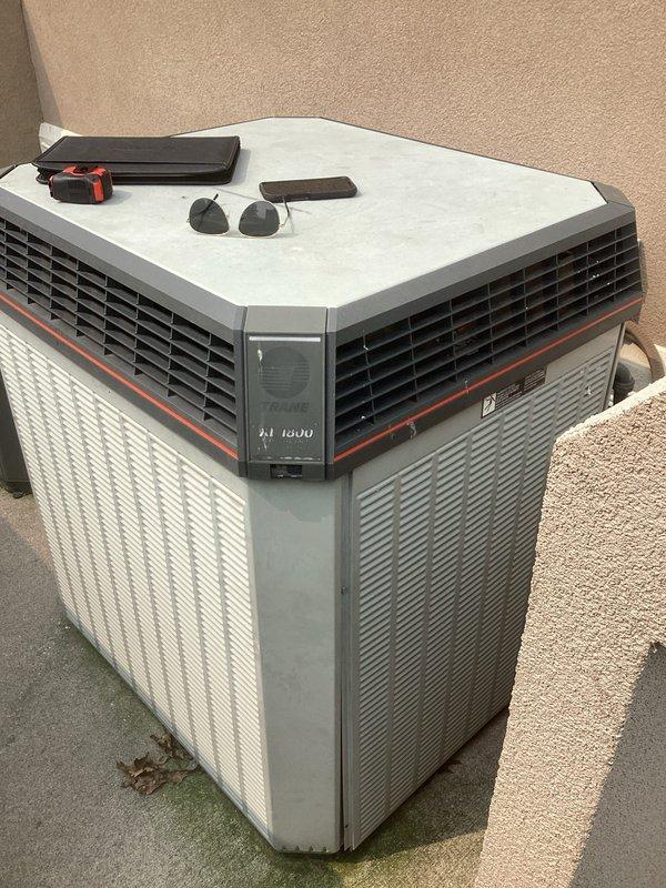 Conducted comprehensive assessment of existing HVAC system for complete furnace and air conditioning replacement. Evaluated outdoor octagonal condenser unit positioned on concrete pad against exterior wall, documenting current equipment condition and installation parameters. Inspected interior mechanical compartment containing furnace, air handler, expansion tank, and associated ductwork, PVC piping, electrical connections, and control boards to determine specifications for replacement equipment and identify any modifications required for new system installation.
