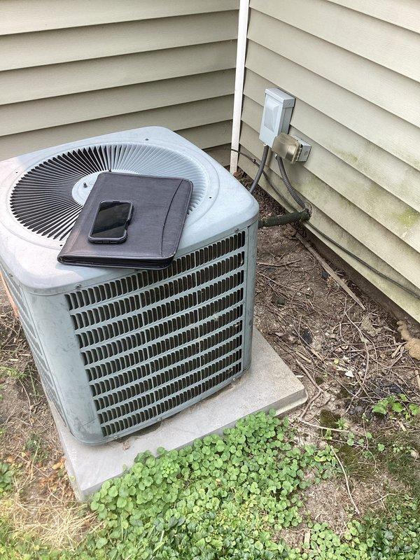 Completed comprehensive estimate for full HVAC system replacement including both furnace and air conditioning units. Assessed existing basement-installed furnace with flexible duct connections and condensate drainage system, along with outdoor condensing unit mounted on concrete pad with electrical disconnect. Documented current equipment condition, measured installation space constraints, photographed existing components, and provided replacement recommendations for complete heating and cooling system upgrade.