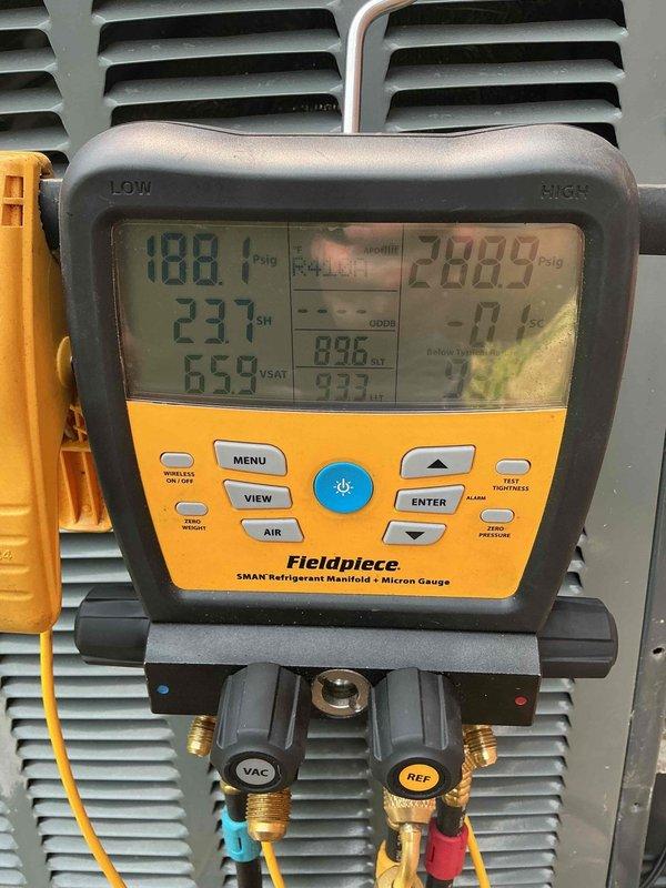Performed diagnostic assessment on residential air conditioning system. Upon arrival, communicated with customer that full system diagnosis would be required before proceeding with leak search and leak seal services. Connected refrigerant manifold gauges to measure system pressures, recording operating pressures and temperatures. Visual inspection revealed significant frost accumulation on refrigerant suction line, indicating potential restriction, low refrigerant charge, or metering device malfunction. Documented system conditions with photos showing pressure readings and frosted copper line with oxidation present. Deferred leak search procedure pending completion of comprehensive diagnostic evaluation to properly identify root cause of system malfunction.