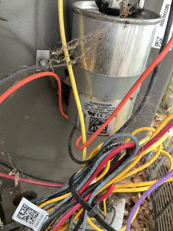 Completed routine maintenance on a 4-year-old air conditioning system. Inspected electrical components including capacitor and wiring connections, removed debris accumulation from unit housing, and verified system operation. All components found to be functioning within normal parameters.
