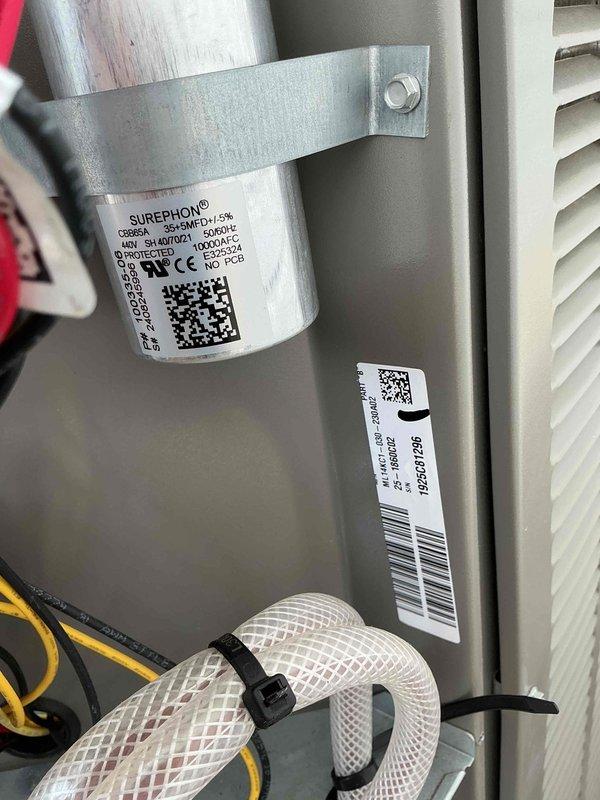 Responded to service call regarding newly installed AC units causing excessive noise during startup and dimming of household lights. Upon inspection, observed HVAC system installation in basement utility area with furnace and associated ductwork. Examined equipment components including motor assembly, electrical connections, and control systems. Documented current system configuration showing white PVC piping, metallic ductwork, and electrical wiring connections. Photographed equipment labels and specifications on units for reference. Issues indicate potential electrical concerns related to inrush current draw during compressor startup, which may require evaluation of dedicated circuit capacity and hard start kit installation to reduce startup amperage and minimize voltage drop affecting household lighting circuits.