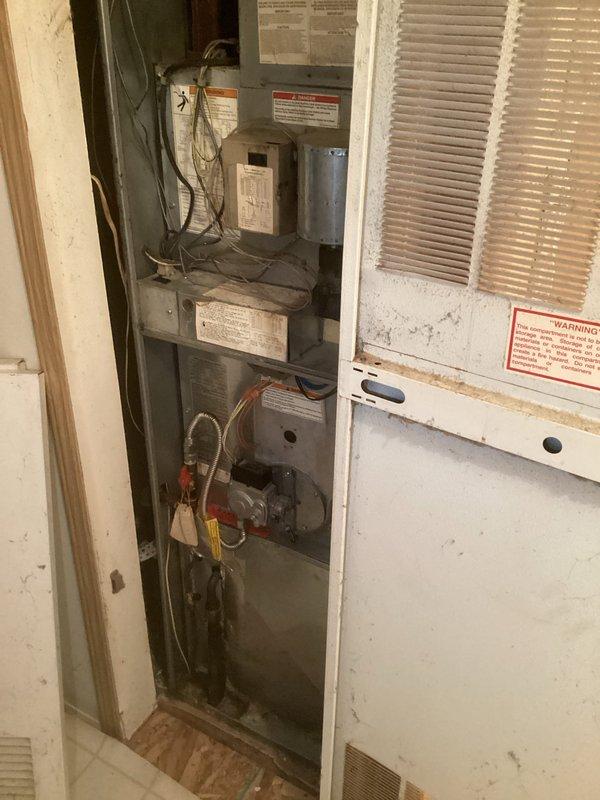 Conducted comprehensive assessment of existing HVAC system for complete air conditioning replacement. Customer reported inadequate cooling in certain areas of the home, requiring evaluation of both equipment and ductwork distribution. Documented current vertical air handler installation in mechanical closet, noting age-related wear, dust accumulation, and overall system condition. Prepared estimate for complete AC system replacement and recommended camera inspection of ductwork to identify potential blockages, disconnections, or airflow restrictions contributing to uneven temperature distribution throughout the residence.