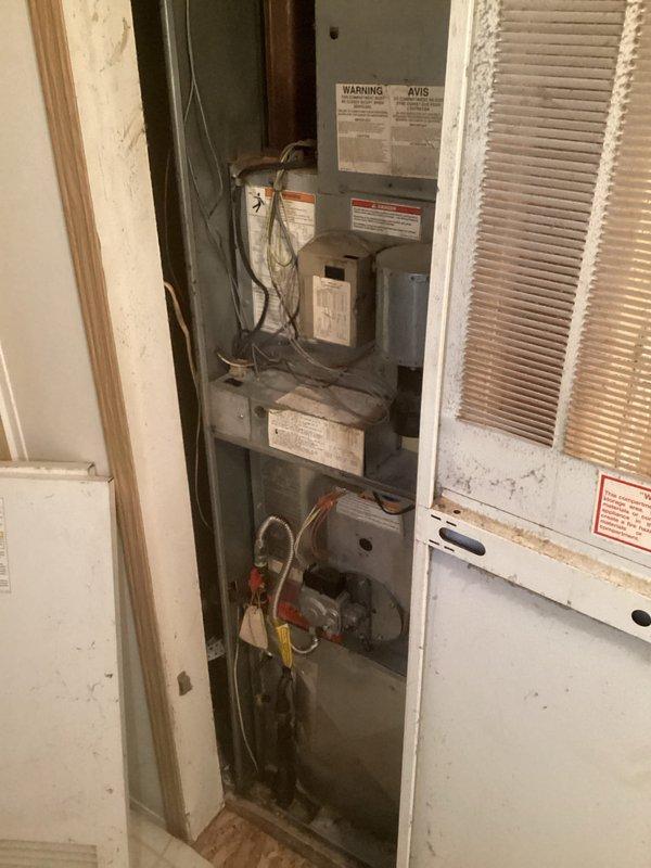 Conducted comprehensive assessment of existing HVAC system for complete air conditioning replacement. Customer reported inadequate cooling in certain areas of the home, requiring evaluation of both equipment and ductwork distribution. Documented current vertical air handler installation in mechanical closet, noting age-related wear, dust accumulation, and overall system condition. Prepared estimate for complete AC system replacement and recommended camera inspection of ductwork to identify potential blockages, disconnections, or airflow restrictions contributing to uneven temperature distribution throughout the residence.