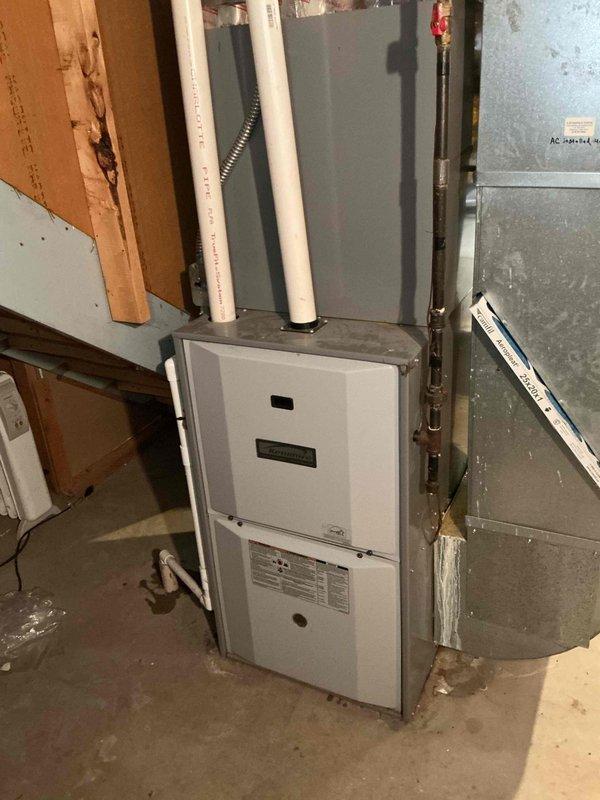 Responded to service call regarding water accumulation around furnace base and air filter installation issue. Upon inspection, accessed evaporator coil assembly and identified condensate drainage concern. Examined HVAC system components including evaporator coil with copper tubing, condensate drain lines with PVC piping, and furnace unit. Documented system condition showing signs of normal operational wear and verified proper access to internal components for maintenance. Investigated filter compartment alignment issue and assessed overall system functionality.