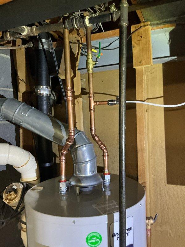 Responded to inspection correction notice regarding water heater clearance requirements per code section 502.5. Rotated water heater to provide proper access and establish compliant 30-inch by 30-inch level working space in front of control side for future inspection, service, and maintenance activities. Verified proper clearances and documented final positioning with photographs showing code-compliant installation and level verification.