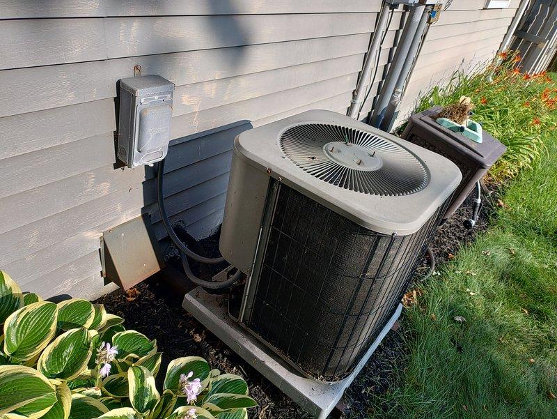 # No Cool Service Call - 20-Year-Old AC Unit

Responded to a no cooling complaint on a 20-year-old outdoor air conditioning system. Upon arrival, performed visual inspection of the condenser unit and accessed the electrical compartment to diagnose the issue. Examined the dual capacitor configuration, wiring connections, and control board for signs of failure or degradation. 

Given the age of the equipment and the nature of the failure, discussed repair versus replacement options with the property owner. The unit has exceeded its expected service life, and investing in major repairs may not be cost-effective. Documented the system condition with photographs showing the exterior unit positioning, electrical components, capacitors, wiring harness, and control board assembly. 

Provided recommendations for next steps based on the diagnostic findings and the advanced age of the equipment.