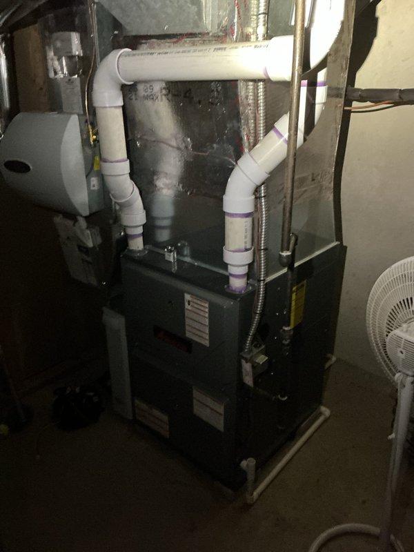 Completed preventative maintenance on a 12-year-old residential cooling system during the scheduled 9-1 service window with advance customer notification. Inspected all major HVAC components including the furnace unit, condensate drainage system with PVC piping, and associated mechanical equipment in the basement utility area. All systems evaluated and found to be operating within normal parameters with no immediate service needs identified at this time.