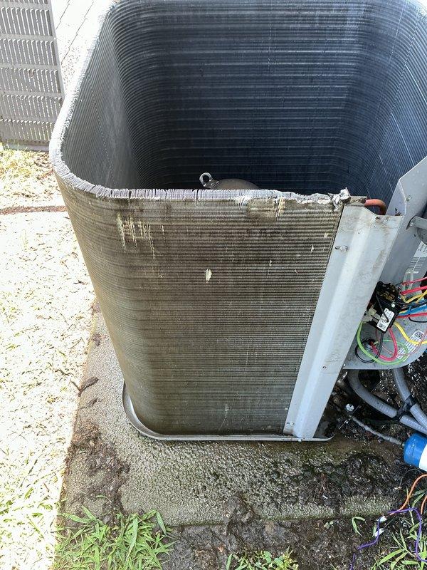 Completed preventive maintenance tune-up on 13-year-old residential air conditioning system. Performed comprehensive inspection of outdoor condenser unit, noting significant dirt and debris accumulation on condenser coil fins requiring cleaning attention. Inspected electrical components at disconnect box and condenser unit, verified all wiring connections secure, and confirmed proper system operation. Unit operational upon service completion.
