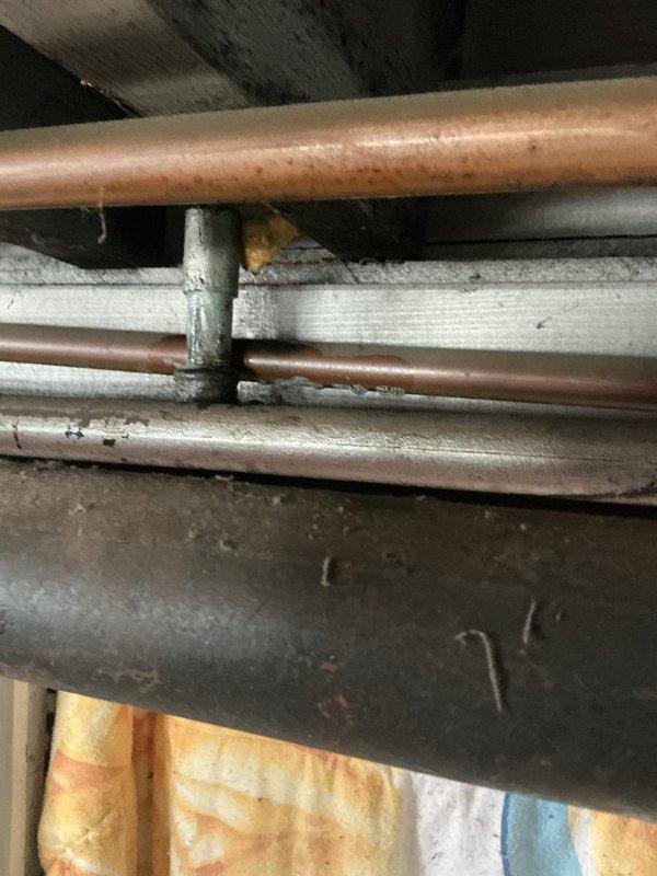 Responded to gas leak emergency per gas company requirement. Conducted comprehensive pressure test on residential gas piping system to identify leak location and verify system integrity. Inspected aged copper gas distribution network including multiple horizontal and vertical pipe runs, isolation valves, and circulation components showing significant oxidation and patina consistent with older installation. Performed systematic pressure testing protocol to isolate compromised section and documented existing piping conditions throughout basement utility area. System evaluated and findings documented with photographic evidence for gas company verification and customer records.