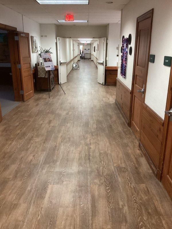 Conducted site evaluation for mini-split installation in commercial assisted living facility with entry point on Seaman Road-facing side. Assessed existing electrical infrastructure, including main breaker panel capacity and available circuits, and surveyed interior hallway layout to determine optimal equipment placement and refrigerant line routing through institutional corridor with wood trim wainscoting and drop ceiling access points.