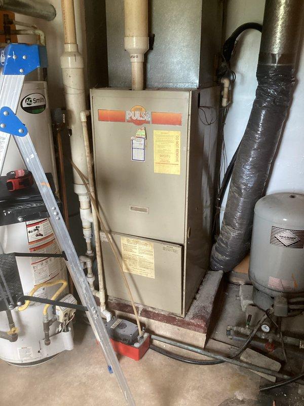 Conducted comprehensive HVAC system evaluation for existing Pulse furnace installation with associated ductwork and venting components. Assessed current equipment condition, measured system specifications, documented installation configuration including PVC condensate drainage, metal supply plenum, and flexible ductwork connections to provide detailed replacement estimate and equipment recommendations.