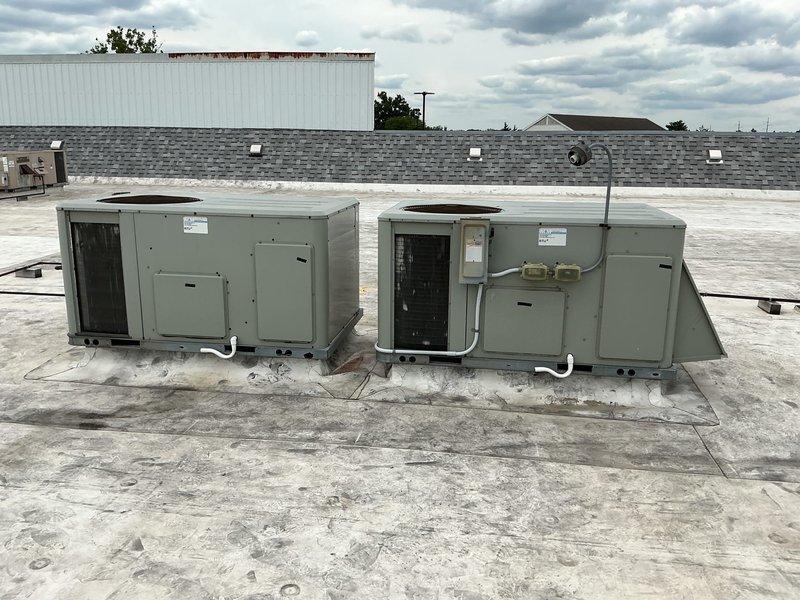 Conducted site assessment of two American Standard rooftop package units on commercial flat roof installation. Documented current equipment condition through photographs, verified unit model information, and took detailed measurements of both units to determine replacement specifications. Inspected access panels, internal components, electrical conduit connections, and mounting configurations to ensure accurate parts identification and sizing for upcoming replacement project.