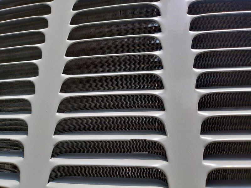 Responded to no cooling complaint on 5-year-old residential air conditioning system. Upon arrival, confirmed outdoor condensing unit fan motor was not operating and system was delivering lukewarm air to living space. Performed diagnostic assessment of outdoor unit, inspecting condenser fan motor, start/run capacitor, and contactor operation. Inspected condenser coil condition through protective grille, noting clean fins and adequate airflow passages. Identified failed component preventing proper heat rejection from refrigeration system. Replaced defective part, restored power to unit, and verified proper fan motor operation and amperage draw. Cycled system through complete cooling cycle, confirmed adequate airflow across condenser coil, and verified cold air delivery at supply registers. Unit restored to normal cooling operation with all safety controls functioning properly.