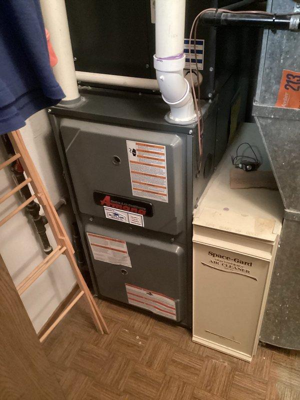 Conducted comprehensive assessment of existing residential HVAC system for complete air conditioning replacement. Evaluated current Amana condenser unit located on exterior concrete pad, noting operational status and existing electrical connections via weatherproof disconnect box. Inspected indoor equipment including furnace, air handler, and Space-Gard air filtration system in basement mechanical room. Documented refrigerant line routing, PVC condensate drainage, electrical service, and overall system configuration. Performed equipment measurements and specifications review to prepare replacement estimate for new air conditioning system compatible with existing furnace and ductwork infrastructure.