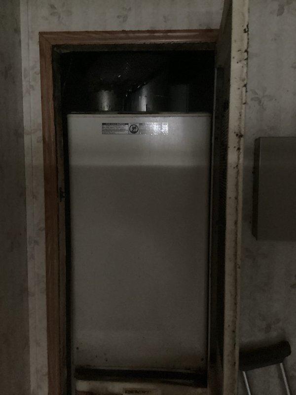 Conducted on-site evaluation for complete HVAC system replacement at residential property. Assessed existing outdoor condenser unit showing significant weathering, dirt accumulation, and age-related deterioration on exterior housing. Documented current refrigerant line routing, PVC conduit configuration along exterior wall, and ground-level placement adjacent to foundation. Evaluated indoor furnace unit located in basement alcove, noting existing ductwork connections and electrical service panel proximity. Provided comprehensive replacement estimate for new air conditioning condenser and furnace system to address equipment age and operational concerns.