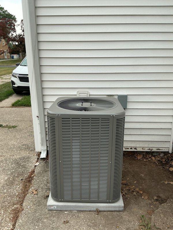 # HVAC Complete System Installation

Completed full residential HVAC system installation consisting of an 80% AFUE upflow furnace in A-cabinet configuration, 2-ton evaporator coil, and 2-ton Lennox condensing unit (AHRI Certificate #215580245). The outdoor condensing unit was positioned on a concrete pad against the exterior wall with proper clearances maintained for adequate airflow around all louver panels. Electrical disconnect box was mounted to exterior siding for code-compliant service accessibility. Black electrical conduit and wiring were routed from the building to the condensing unit. The upflow furnace and evaporator coil were installed indoors per manufacturer specifications to match the outdoor unit capacity. All refrigerant lines were properly connected, evacuated, and charged. System was tested for proper operation including airflow verification, electrical connections, and thermostat communication. Installation meets all applicable building codes and manufacturer requir