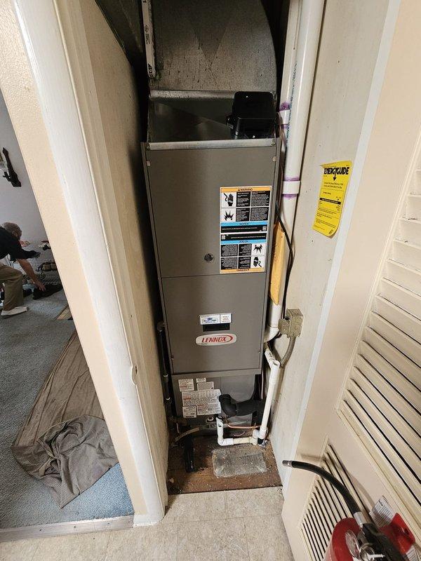 Completed full HVAC system installation including Lennox single-stage condenser unit and downflow cased evaporator coil. Due to space constraints in utility closet, installed shorter coil with maximum 16-inch height clearance to accommodate existing furnace configuration. Relocated condenser unit 3 feet from gas meter on new concrete pad for proper clearance and code compliance. Ran new refrigerant line set connecting outdoor condenser to indoor coil. Installed new thermostat for system control. All components properly sized and installed per manufacturer specifications. System tested and operational upon completion.