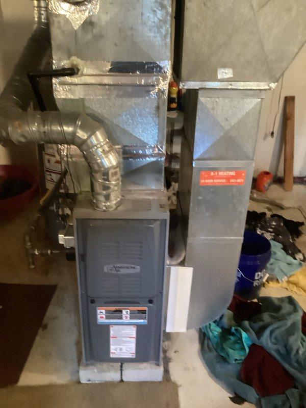 Conducted comprehensive site evaluation for complete air conditioning system replacement at residential property. Assessed existing HVAC infrastructure including basement-mounted furnace with connected ductwork and exterior condenser unit with electrical connections. Documented current system configuration, electrical service components including meter base and disconnect switch, and existing ductwork layout to provide accurate replacement specifications and equipment recommendations for new AC installation.