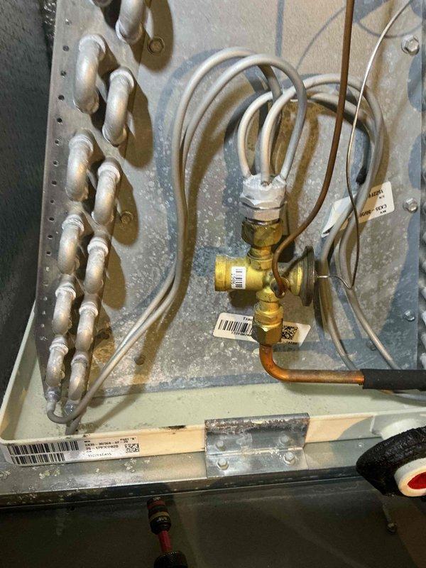Completed scheduled maintenance on a 4-year-old air conditioning system. Inspected outdoor condensing unit, verified proper operation of compressor and condenser fan, checked refrigerant pressures, and examined indoor heating components including heat exchanger and gas valve assembly. All components found to be functioning within normal parameters with routine cleaning performed on outdoor unit.
