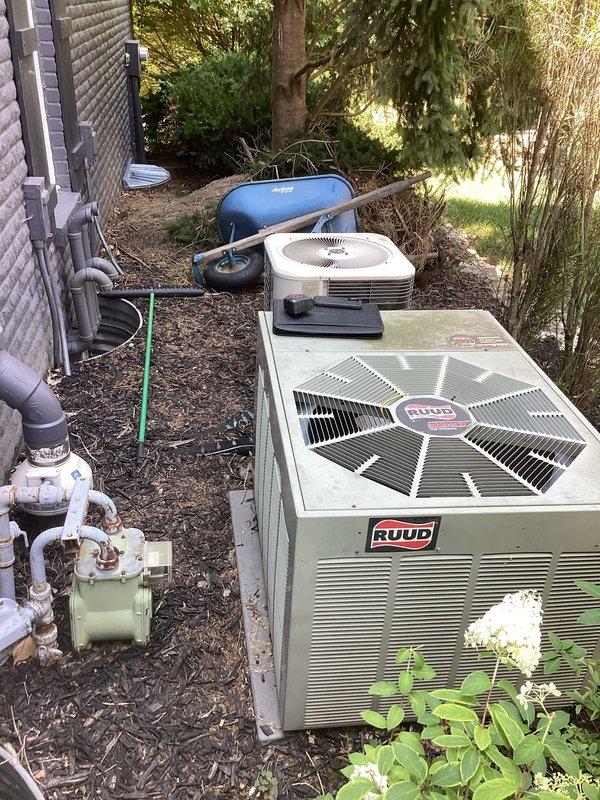 Conducted comprehensive assessment of existing HVAC system for complete air conditioning replacement. Evaluated current RUUD condenser unit and associated equipment including evaporative cooler, PVC drainage system, and exterior mechanical components. Documented existing installation configuration, noting foundation-mounted equipment placement, drainage piping arrangement, and electrical connections. Provided detailed replacement estimate for new AC system with agreement to credit previously installed fan motor toward total equipment upgrade cost upon customer approval.