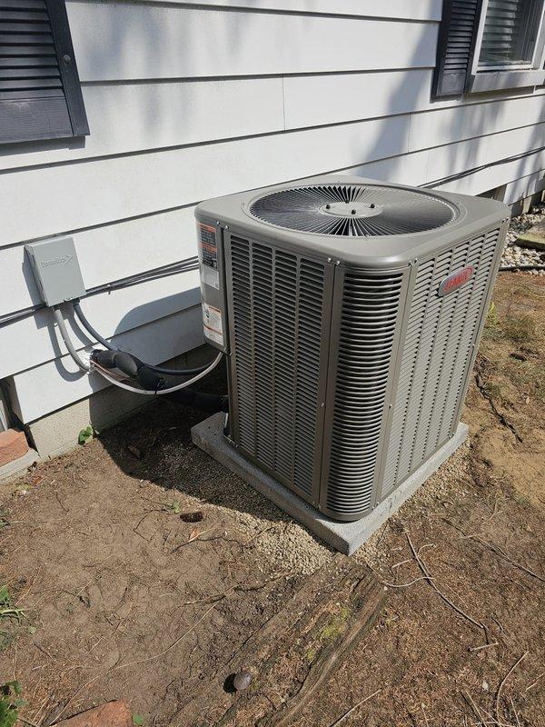 Completed full HVAC system retrofit installation including upflow cased coil air handler in basement utility area and single-stage condenser unit on exterior concrete pad. Installed new 3/4" x 30' lineset, electrical disconnect and whip, and programmed new thermostat for system operation. Repositioned existing Aprilaire humidifier to accommodate new air handler configuration, ensuring proper integration with updated ductwork and maintaining all safety clearances per manufacturer specifications.