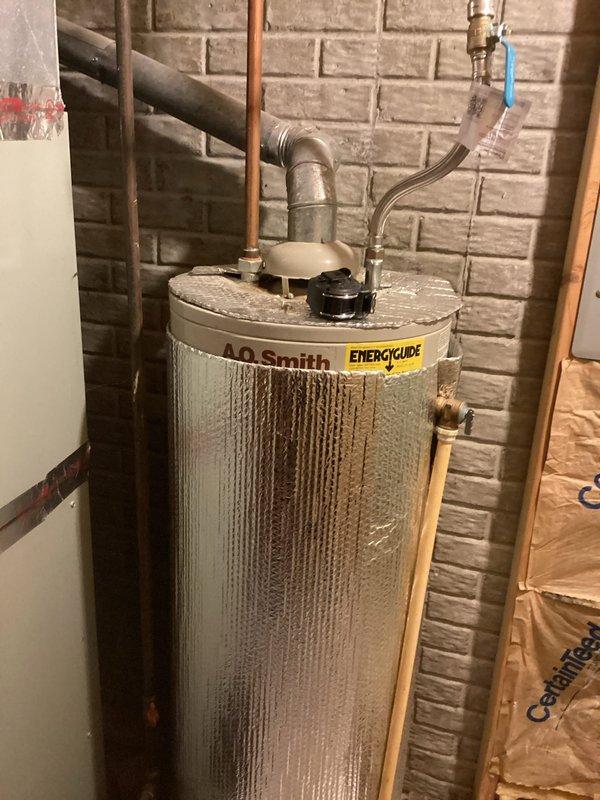 Completed comprehensive estimate for residential furnace replacement in basement utility area. Assessed existing beige-colored furnace unit with current PVC venting configuration and documented equipment specifications, manufacturer labels, and existing ductwork connections. Evaluated mechanical room layout including proximity to A.O. Smith water heater, available clearances, structural considerations with exposed wall studs, and accessibility for future installation and maintenance requirements.