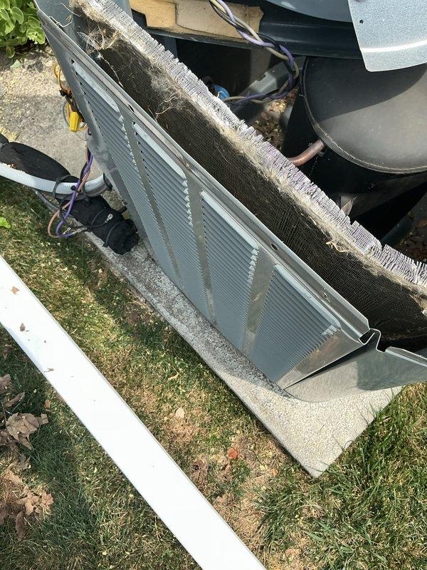 Completed annual maintenance on 12-year-old air conditioning system. Removed and cleaned condenser coil which showed significant dirt and debris accumulation on exterior fins, inspected electrical connections and fan assembly operation, and replaced indoor air filter which displayed dust buildup. All components tested and system returned to normal operation.