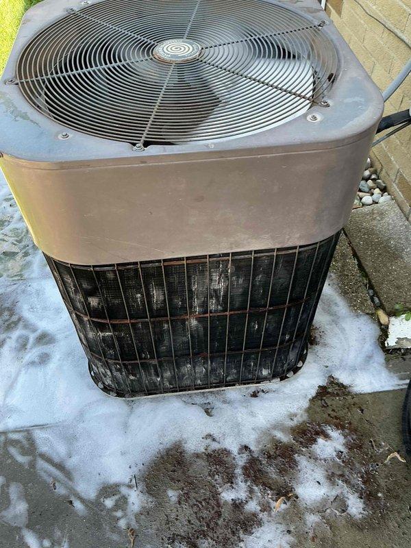 Completed standard air conditioning tune-up on Lennox outdoor condenser unit. Performed comprehensive system inspection, cleaned condenser coils showing weathering and dirt accumulation on vertical fins, verified fan operation and electrical connections, and confirmed unit operational status. System age undetermined at time of service.