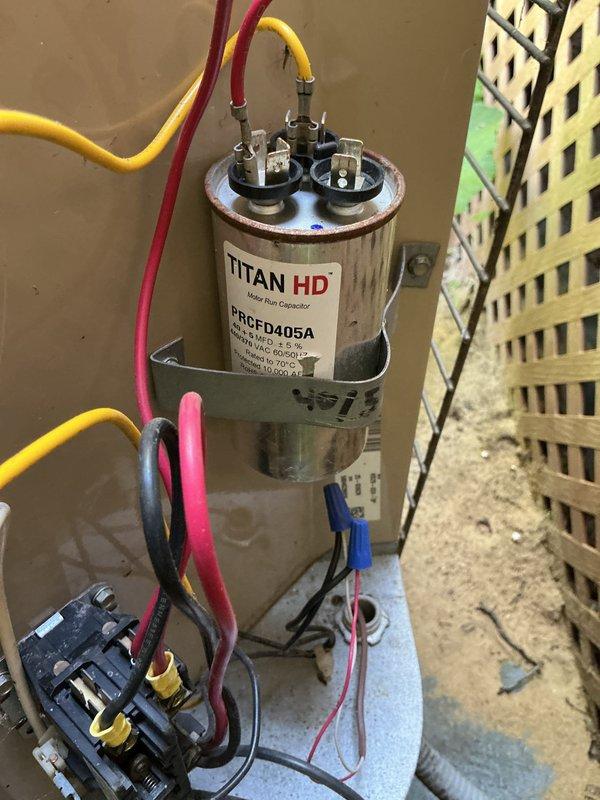 Completed annual maintenance on 21-year-old Lennox air conditioning system. Inspected electrical components including TITAN HD motor run capacitor (model PRCFD405A) and contactor, verifying proper connections and functionality. Cleaned exterior condenser unit, removing significant accumulation of lint, dust, and debris from top grille and surrounding areas. All components tested and operating within normal parameters upon completion.