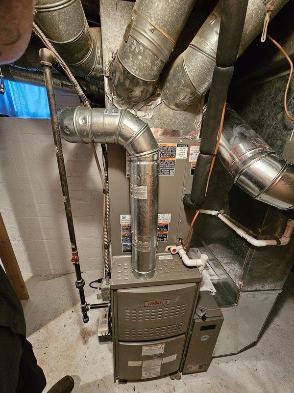 Completed full HVAC system installation including AHRI-certified 70,000 BTU upflow furnace with B cabinet configuration, 2.5 ton upflow uncased evaporator coil, and single-stage condenser unit. Installed new 3/4" x 30' refrigerant line set routed through grid ceiling, 5" metal filter rack, 12-gallon whole-home humidifier, condensate pad, and electrical disconnect with whip. Reused existing thermostat and verified all components properly leveled, secured, and operational per manufacturer specifications.