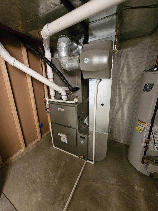 Completed full HVAC system installation in residential basement including 5-ton upflow cased coil, 96% efficiency 135,000 BTU upflow furnace with return-based configuration, and single-stage condenser unit. Installed new 7/8" x 50' refrigerant line set, condenser pad, disconnect and whip, 17-gallon humidifier, 5" filter rack, and WiFi-enabled thermostat for remote system control. Verified proper drainage with condensate trap installation, ensured level equipment placement, and confirmed all ductwork connections and electrical components were properly secured per manufacturer specifications.