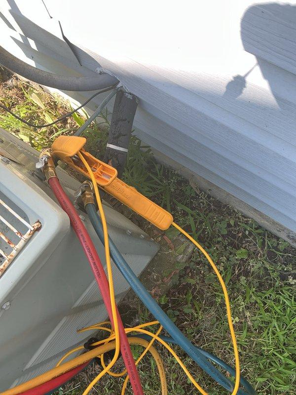 # HVAC Tune-Up Completed

Performed comprehensive tune-up service on a 20-year-old residential air conditioning system. Connected refrigerant gauges to the outdoor condensing unit to check system pressures and verify proper refrigerant charge levels. Inspected both outdoor and indoor equipment components, including the basement air handler and associated ductwork. System operational parameters were evaluated and unit confirmed to be functioning within acceptable ranges for its age.