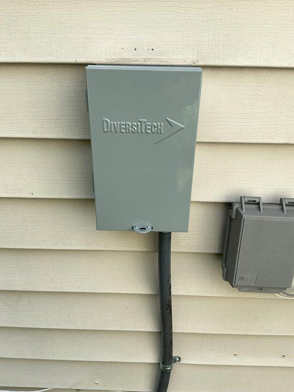 Returned to site to complete installation of DiversiTech electrical disconnect box and whip assembly for outdoor A/C unit. Successfully mounted weatherproof disconnect enclosure to exterior wall, installed flexible conduit (whip) from disconnect to unit, and secured all connections per code requirements.