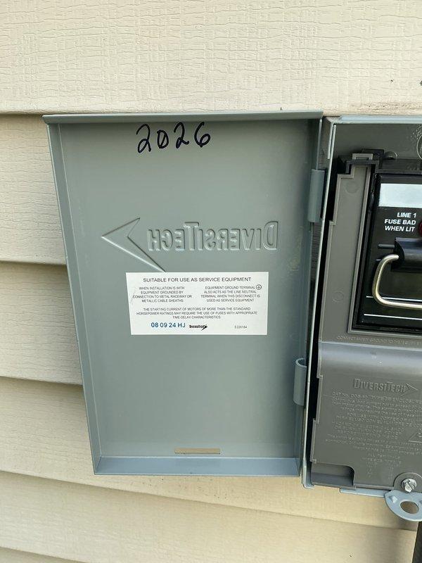 Returned to site to complete installation of DiversiTech electrical disconnect box and whip assembly for outdoor A/C unit. Successfully mounted weatherproof disconnect enclosure to exterior wall, installed flexible conduit (whip) from disconnect to unit, and secured all connections per code requirements.