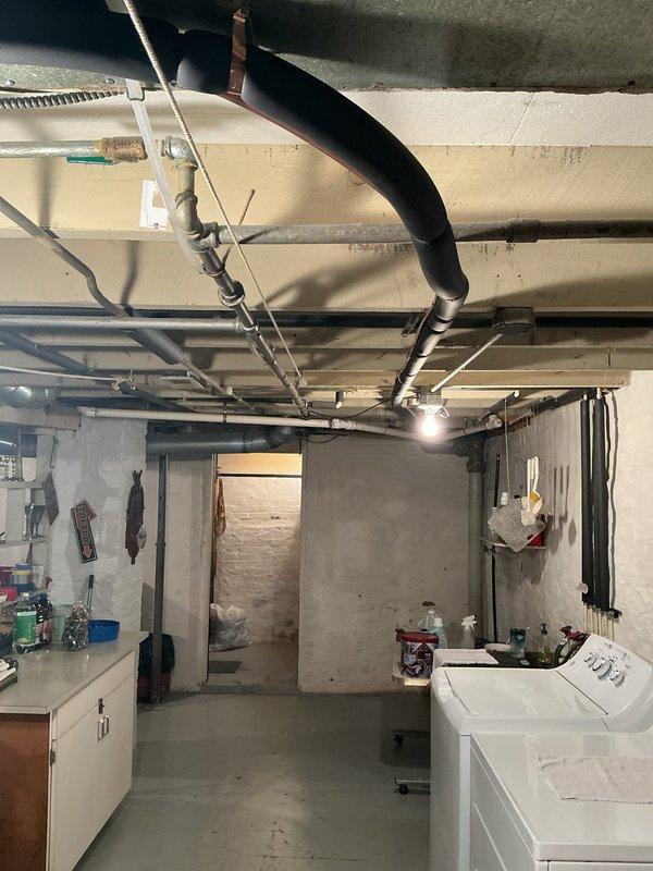 Completed full HVAC system installation in basement mechanical room, installing an upflow cased coil A/C package with single-stage condenser. Ran new 3/4" x 30' lineset from indoor coil to outdoor unit, ensuring proper refrigerant line sizing and insulation. Placed new equipment pad on top of existing pad for outdoor condenser, providing stable, level foundation. Installed new disconnect and whip for electrical connections to outdoor unit, meeting code requirements. Reused existing thermostat, verifying compatibility with new system. All ductwork connections completed with proper sealing, condensate drainage established with pump system, and unit tested for proper operation and airflow.