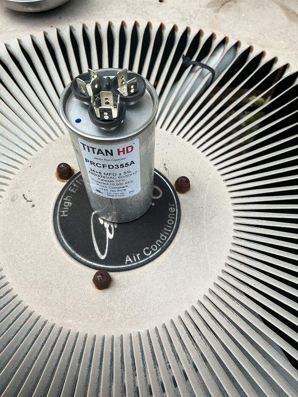 Completed comprehensive A/C tune-up service on residential split system. Inspected outdoor condenser unit, verified proper operation of compressor and condenser fan motor, checked TITAN HD capacitor specifications and electrical connections, and examined condenser coil fins for damage or debris buildup. Noted customer has adequate supply of 20x25x1 pleated air filters on hand for regular maintenance intervals.