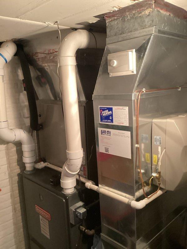 Conducted comprehensive assessment of existing HVAC system for furnace replacement estimate. Evaluated current furnace unit, associated ductwork, PVC ventilation and drainage piping, and refrigerant line connections. Documented equipment specifications, manufacturer information, and system configuration including air handler cabinet and copper line routing. Photographed installation layout, mechanical connections, and surrounding utility space conditions to provide accurate replacement recommendations and ensure proper sizing for new equipment installation.