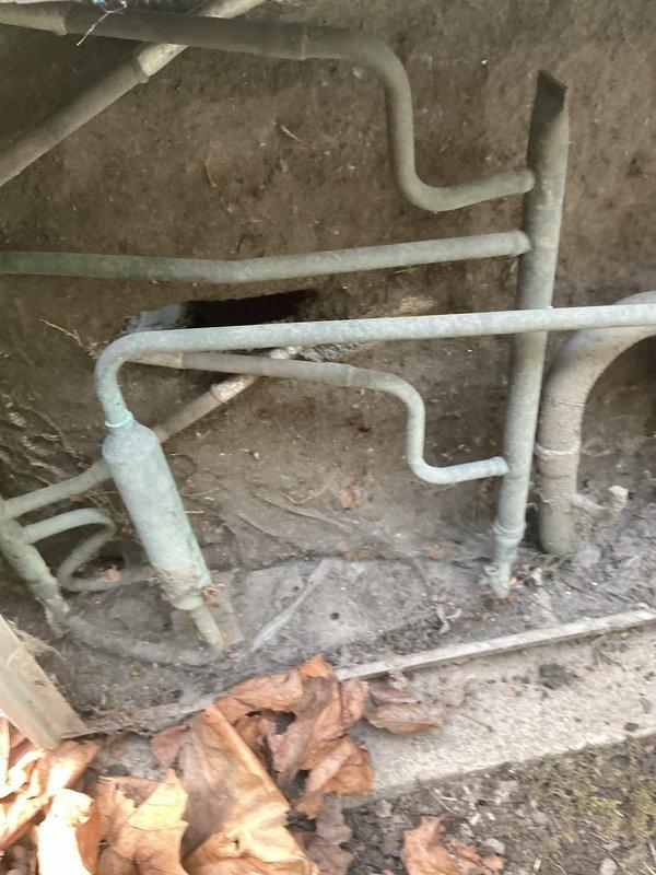Responded to emergency no-cooling call on residential air conditioning unit approximately 15 years old. Upon arrival, confirmed thermostat set to 72°F while indoor temperature measured 80°F. Inspection revealed outdoor condenser unit with severely restricted airflow due to heavy accumulation of dirt, dust, lint, and debris coating the condenser coil fins. Removed top panel to access internal components and documented condition of coil assembly and refrigerant line insulation showing significant weathering and deterioration. The outdoor unit exhibited normal operational wear consistent with age, but debris buildup on coil surfaces was substantially impacting heat transfer efficiency and system performance. Recommended thorough coil cleaning and system evaluation to restore proper cooling capacity.