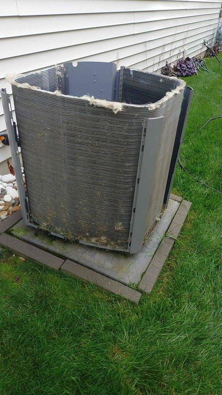 Performed preventative maintenance tune-up on 6-year-old residential air conditioning system. Unit showed signs of environmental wear with dirty condenser coils, accumulated debris, and missing top protective grille exposing fan assembly. Cleaned condenser coils, removed debris from unit exterior, and documented compromised protective grille requiring future replacement to prevent weather damage and ensure safe operation.
