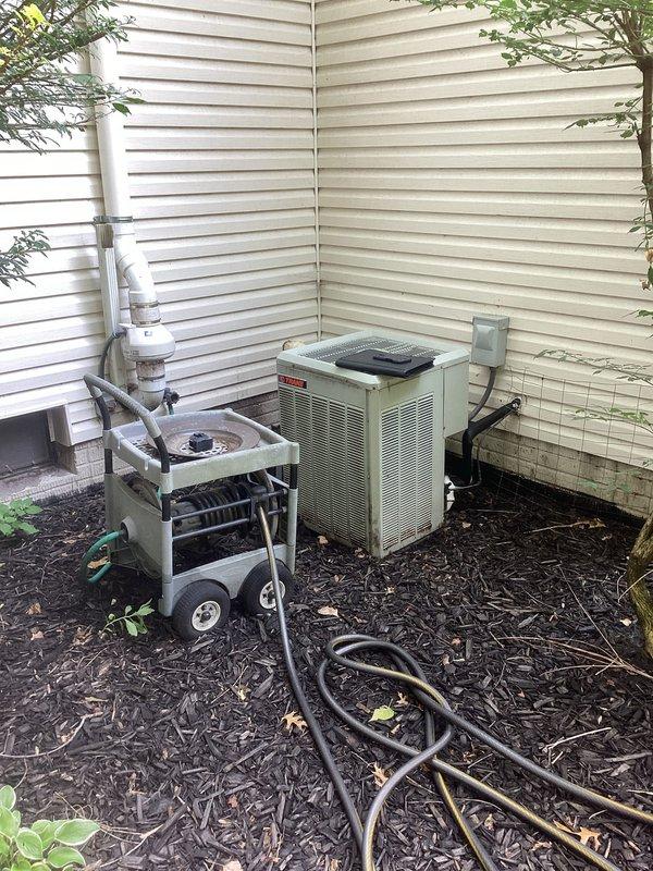 Completed comprehensive estimate for full HVAC system replacement at residential property. Evaluated existing indoor air handler unit located in utility closet showing significant dust accumulation and aging components, along with outdoor condensing unit positioned in exterior corner area on mulch bed. Assessment included inspection of current ductwork configuration with flexible metallic connections, existing PVC condensate drainage system, electrical connections, and thermostat controls to determine complete replacement specifications and equipment requirements for new high-efficiency system installation.