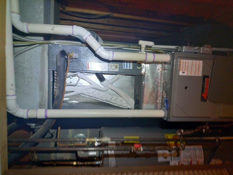 Completed comprehensive tune-up service on a 12-year-old HVAC system including both indoor furnace/air handler unit and outdoor condenser. Removed condenser access panel and inspected internal components, noting significant accumulation of organic debris around compressor and coils; cleaned unit interior to restore proper airflow and heat transfer efficiency. Verified operation of all system components, inspected refrigerant lines, electrical connections, condensate drainage system, and gas line connections with proper safety protocols observed throughout service.