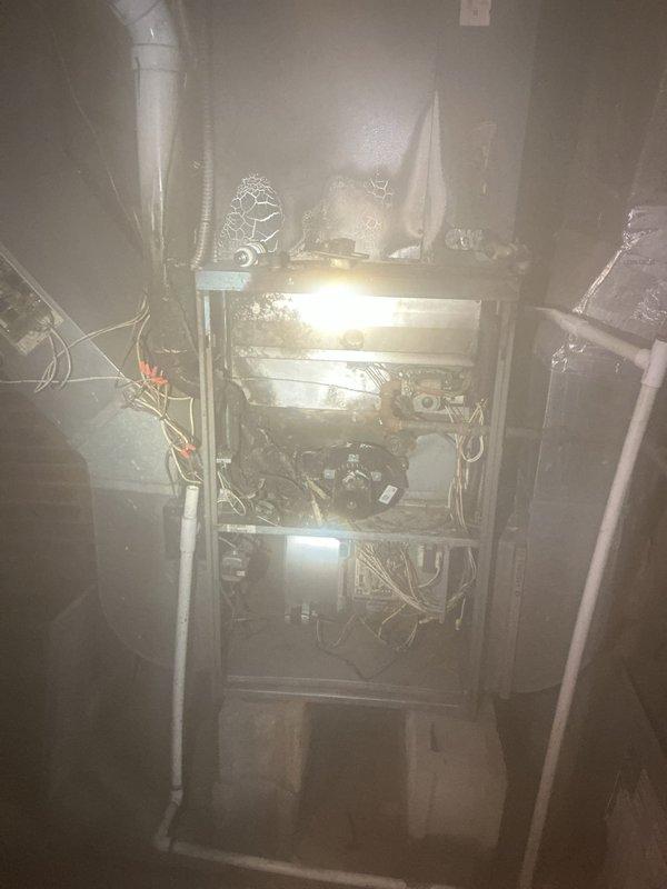 Completed comprehensive assessment of existing residential forced-air furnace system located in basement utility area. Evaluated current unit condition, including blower motor assembly, electrical wiring harnesses, and internal mechanical components. Inspected associated ductwork system with metallic insulation throughout ceiling space, noting multiple connection points and aged infrastructure. Documented existing HVAC installation configuration, flexible ductwork connections, and electrical panel proximity for replacement planning. Provided detailed estimate for complete furnace replacement including removal of existing unit and installation of new equipment to current code specifications.