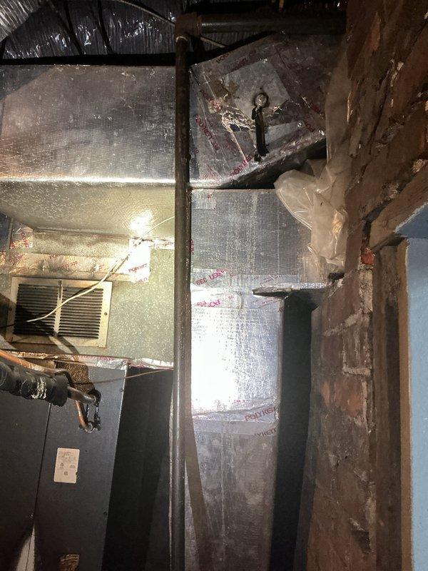 Completed comprehensive assessment of existing residential forced-air furnace system located in basement utility area. Evaluated current unit condition, including blower motor assembly, electrical wiring harnesses, and internal mechanical components. Inspected associated ductwork system with metallic insulation throughout ceiling space, noting multiple connection points and aged infrastructure. Documented existing HVAC installation configuration, flexible ductwork connections, and electrical panel proximity for replacement planning. Provided detailed estimate for complete furnace replacement including removal of existing unit and installation of new equipment to current code specifications.