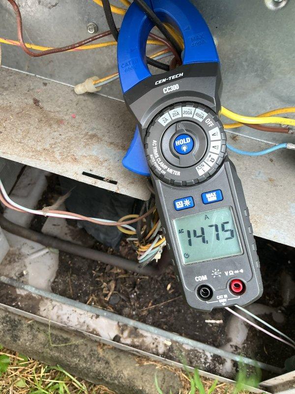 Responded to no-cooling complaint on central air conditioning system. Upon arrival, confirmed outdoor fan motor operating but noted absence of cold suction line temperature, lack of warm discharge air, and no condensate drainage—all indicating compressor failure. Used clamp meter to diagnose electrical issue, measuring 14.75 amps on one circuit and 0.70 amps on compressor circuit, confirming compressor not drawing proper amperage and failing to operate. Identified failed compressor as root cause preventing refrigeration cycle from functioning. Reviewed repair options and system age with customer to determine next steps for restoring cooling operation.