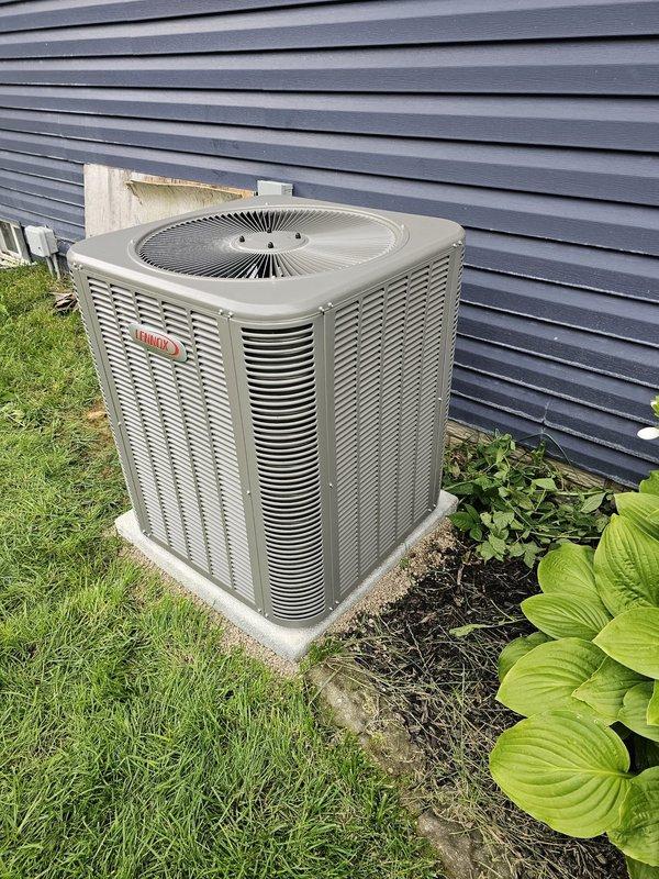 Completed installation of a new Lennox air conditioning package system including outdoor condenser unit and indoor evaporator coil. Positioned the condenser unit on a concrete pad adjacent to the building exterior with proper clearances for airflow and service access. Inside the mechanical room, installed the evaporator coil assembly integrated with the existing furnace system, complete with insulated ductwork connections and proper refrigerant line routing. Ran copper refrigerant lines with white insulation from the outdoor unit to the indoor coil, ensuring proper pitch and support. Installed PVC condensate drain lines with appropriate fittings and slope for proper drainage. Made all electrical connections including power supply to the condenser unit and control wiring between indoor and outdoor components. Pressure tested the refrigerant system, evacuated to manufacturer specifications, and charged with the correct refrigerant type and quantity. Verified all electrical connections, t