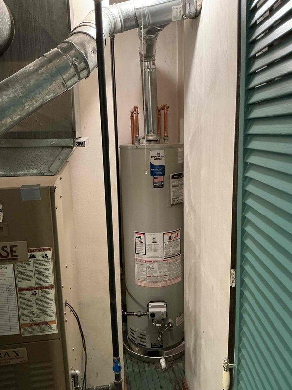 Responded to service call for tanked water heater with pilot light that would not remain lit. Upon arrival, located unit in utility closet off dining room alongside HVAC equipment. Inspected gas water heater and pilot assembly to diagnose ignition failure. Tested thermocouple operation and verified proper gas supply to pilot burner. Cleaned pilot orifice and thermocouple sensor to ensure proper flame detection. Adjusted pilot flame height and repositioned thermocouple in optimal location within pilot flame for reliable heat sensing. Verified pilot light remained lit and cycled main burner to confirm proper operation. System restored to full functionality with pilot maintaining consistent flame and burner responding appropriately to thermostat demand.