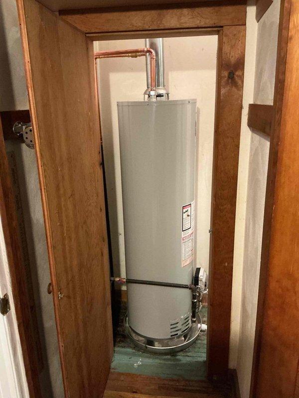 Responded to service call for tanked water heater with pilot light that would not remain lit. Upon arrival, located unit in utility closet off dining room alongside HVAC equipment. Inspected gas water heater and pilot assembly to diagnose ignition failure. Tested thermocouple operation and verified proper gas supply to pilot burner. Cleaned pilot orifice and thermocouple sensor to ensure proper flame detection. Adjusted pilot flame height and repositioned thermocouple in optimal location within pilot flame for reliable heat sensing. Verified pilot light remained lit and cycled main burner to confirm proper operation. System restored to full functionality with pilot maintaining consistent flame and burner responding appropriately to thermostat demand.