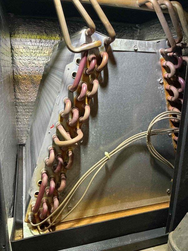 Responded to no-cooling complaint on 16-year-old air conditioning system. Upon arrival, performed diagnostic evaluation of outdoor condensing unit and indoor components. Inspected refrigerant lines, electrical connections, and condensate removal system. Documented existing equipment condition showing significant age-related wear, including corroded chain components and weathered exterior panels. Evaluated system operation, identified failure points, and provided assessment of repair versus replacement options given the unit's age and overall condition.